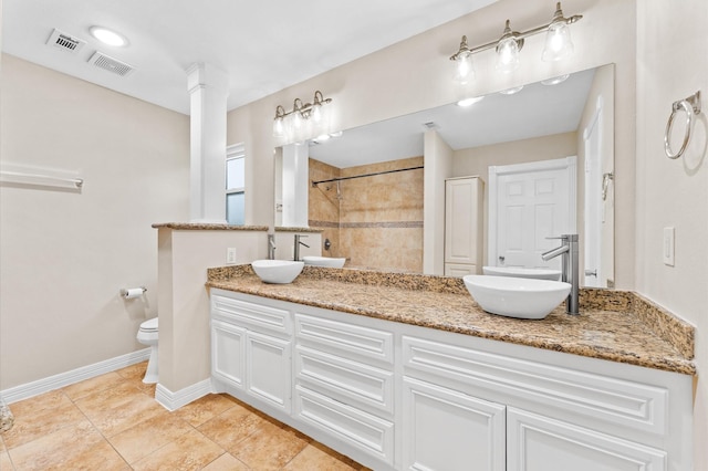 full bath with a tile shower, toilet, a sink, and visible vents