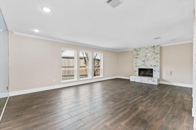 unfurnished living room with dark wood-style floors, ornamental molding, and visible vents