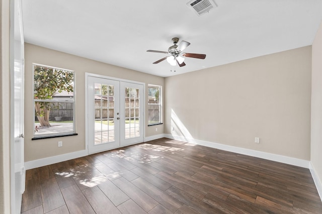 empty room with ceiling fan, a wealth of natural light, french doors, and visible vents