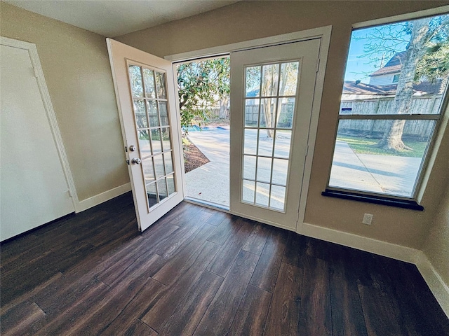 entryway with baseboards, a wealth of natural light, and dark wood-style floors