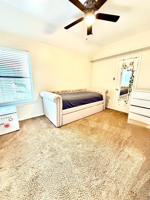 bedroom with carpet, ceiling fan, vaulted ceiling, and baseboards