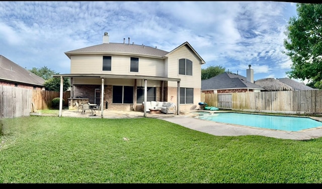 rear view of house with a patio area, a fenced backyard, a fenced in pool, and a yard