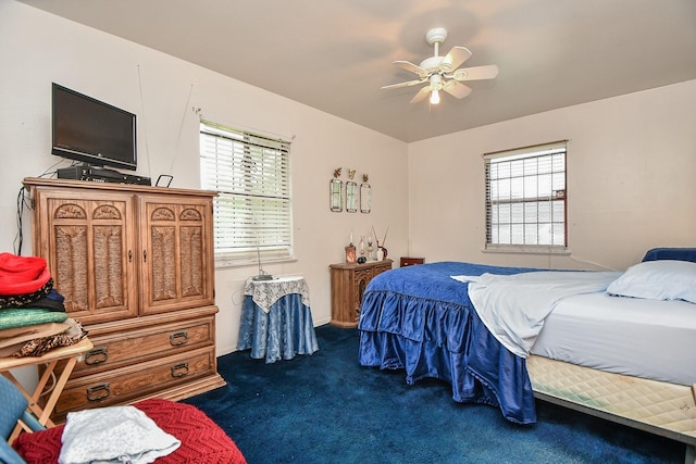 bedroom featuring dark carpet and ceiling fan