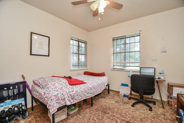 carpeted bedroom featuring baseboards and ceiling fan