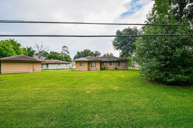 exterior space with a front yard and fence