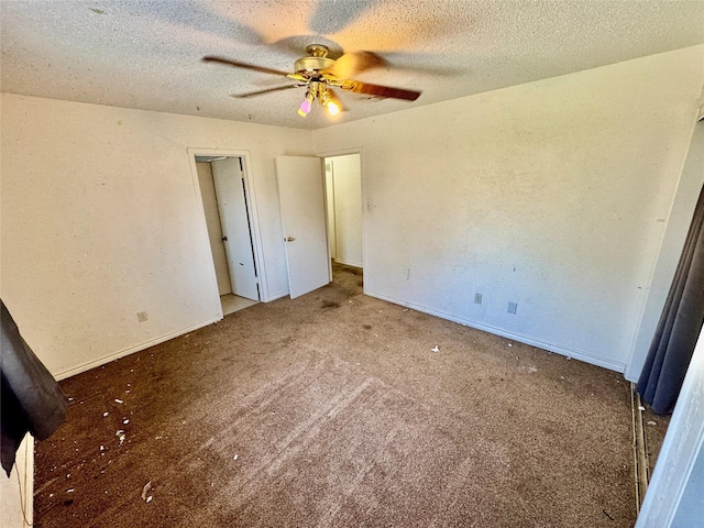 unfurnished bedroom with a ceiling fan, carpet, baseboards, and a textured ceiling