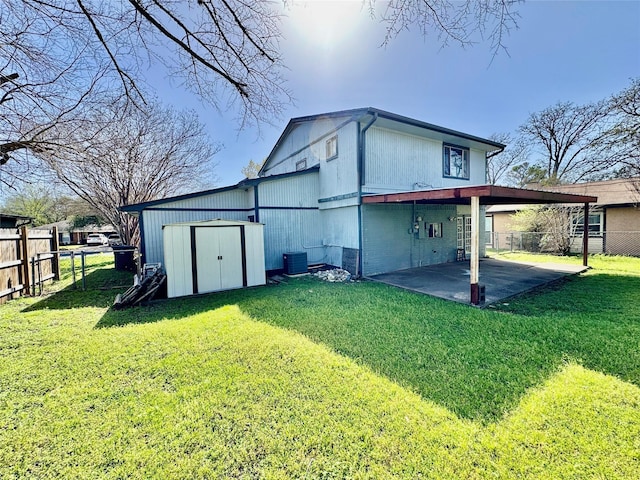 rear view of property featuring a lawn, a fenced backyard, and a patio area