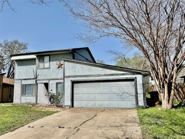 traditional-style home featuring concrete driveway and an attached garage