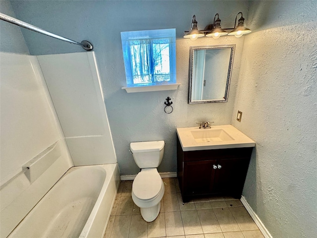 full bath with tile patterned floors, toilet, vanity, and a textured wall