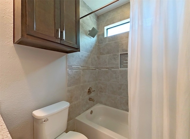 bathroom featuring shower / bath combination with curtain and toilet