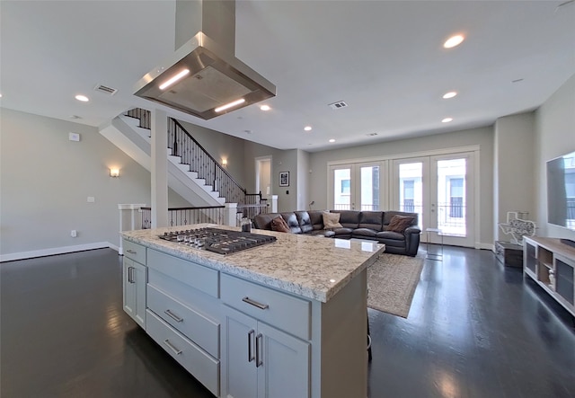 kitchen featuring recessed lighting, island exhaust hood, a kitchen island, and stainless steel gas cooktop