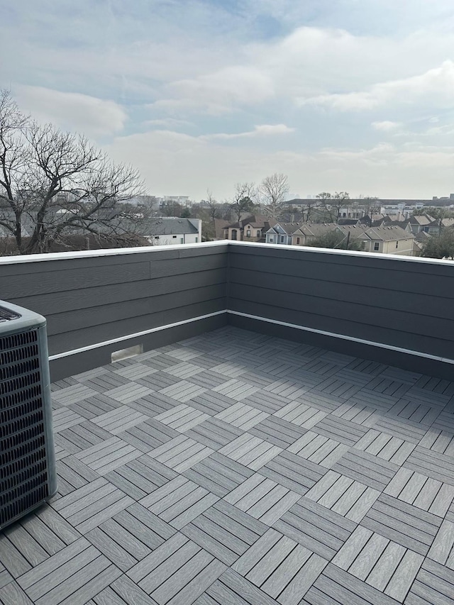 deck with a residential view and central AC