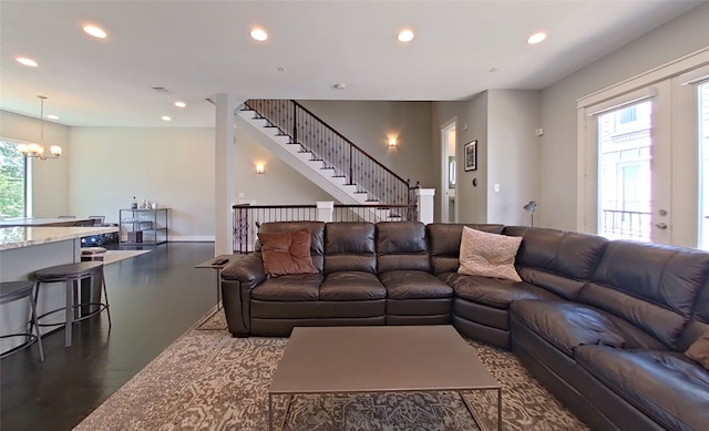 living room featuring visible vents, a notable chandelier, dark wood finished floors, recessed lighting, and stairs