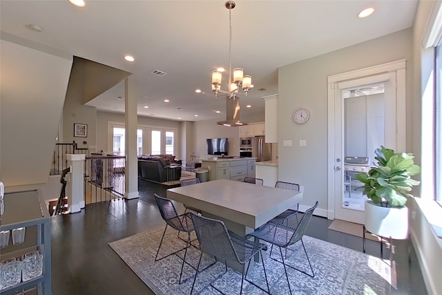 dining area with baseboards, recessed lighting, visible vents, and a chandelier