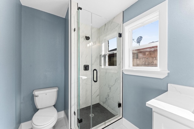 bathroom with a marble finish shower, baseboards, toilet, and vanity