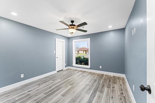 empty room featuring recessed lighting, a ceiling fan, light wood-type flooring, and baseboards