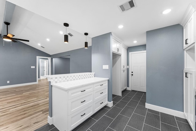 kitchen with visible vents, pendant lighting, light countertops, white cabinets, and a ceiling fan