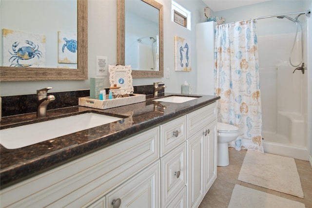 full bathroom featuring a sink, toilet, a stall shower, and double vanity
