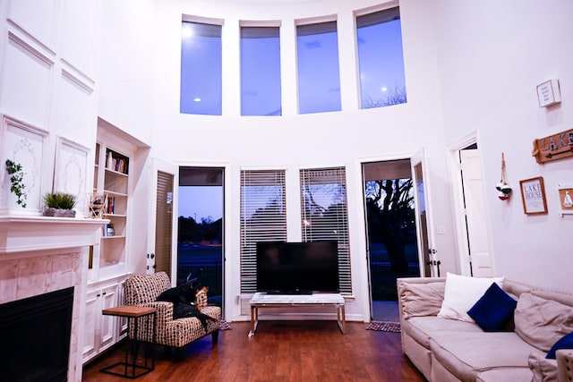 living area featuring a tile fireplace and wood finished floors