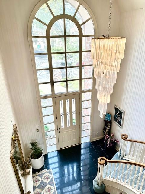 foyer with dark tile patterned floors and a healthy amount of sunlight