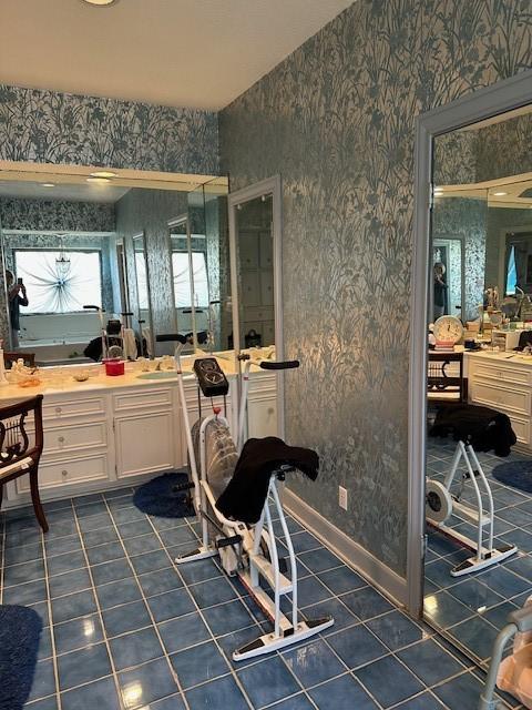 bathroom featuring tile patterned flooring, wallpapered walls, vanity, and baseboards