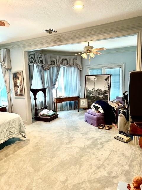 bedroom featuring visible vents, carpet floors, and a textured ceiling