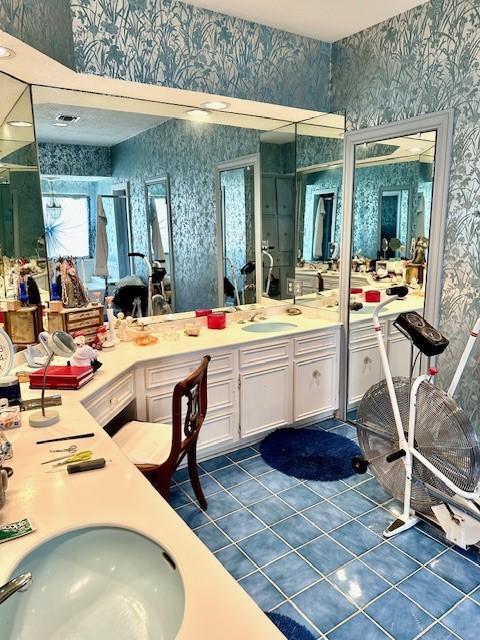 full bath with wallpapered walls, double vanity, tile patterned floors, and a sink