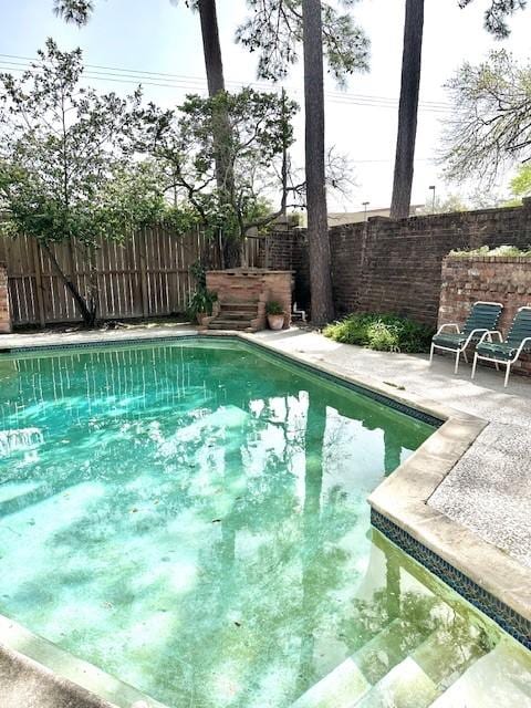 view of pool with a patio area, a fenced backyard, and a fenced in pool