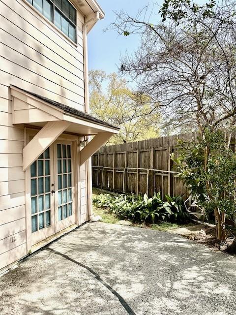 view of patio featuring french doors and fence