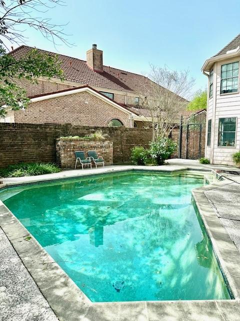 view of pool with a fenced in pool, a fenced backyard, and a patio area