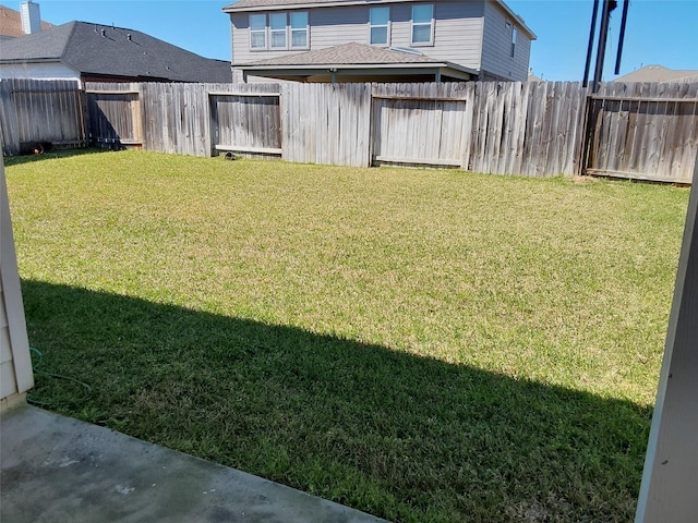 view of yard with a fenced backyard