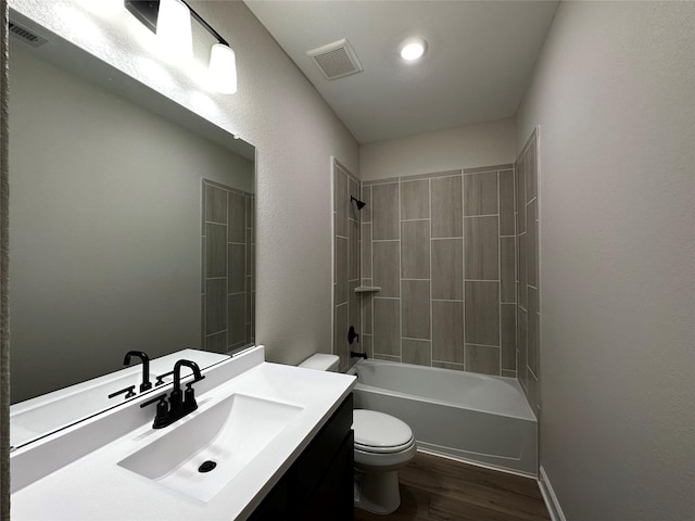 bathroom featuring visible vents, toilet, wood finished floors, and washtub / shower combination