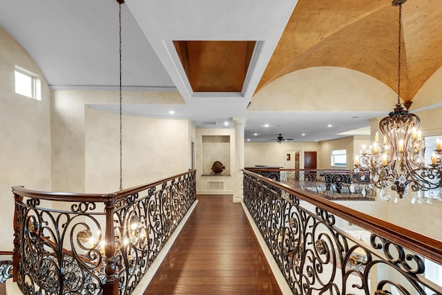 2220 Todville Rd, Seabrook, TX 77586 - hallway featuring wood-type flooring, decorative columns, and a chandelier