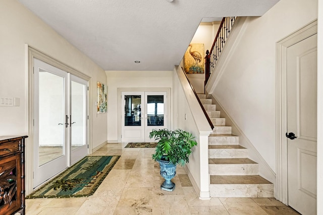 2220 Todville Rd, Seabrook, TX 77586 - foyer entrance featuring stairway, french doors, and baseboards