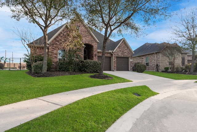 view of front of home with brick siding, a front lawn, fence, concrete driveway, and an attached garage