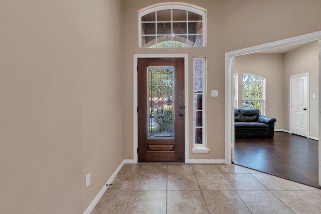 entrance foyer featuring tile patterned floors and baseboards