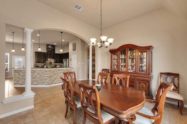 dining room with visible vents, arched walkways, light tile patterned floors, baseboards, and a chandelier