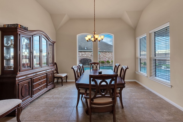 dining room featuring baseboards, lofted ceiling, a chandelier, and light tile patterned flooring