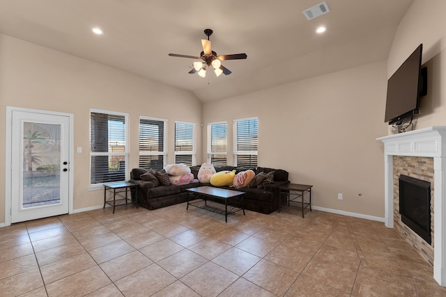 living area with light tile patterned floors, baseboards, visible vents, a fireplace, and ceiling fan