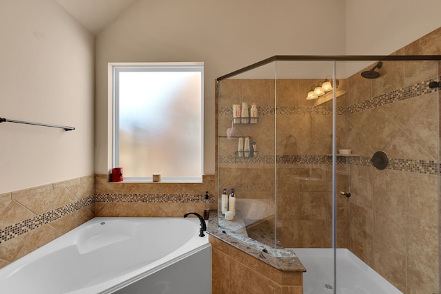 full bath with a garden tub, a stall shower, and vaulted ceiling