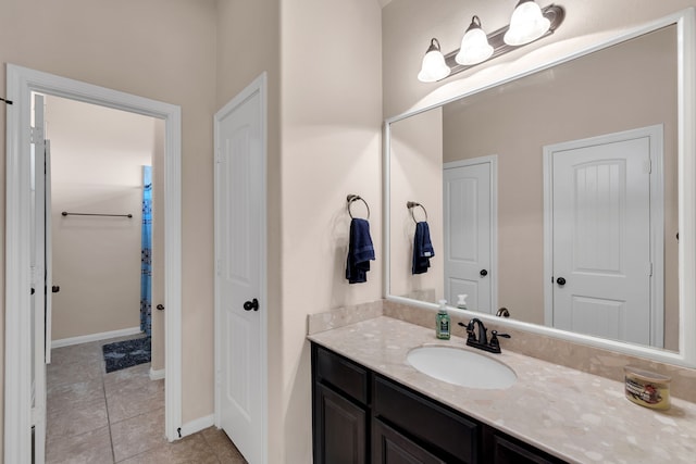 bathroom featuring tile patterned flooring, vanity, and baseboards