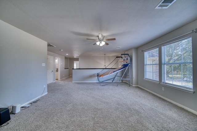 interior space with visible vents, baseboards, and ceiling fan