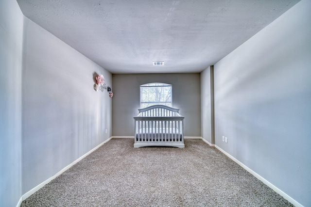 unfurnished bedroom with visible vents, baseboards, and carpet flooring