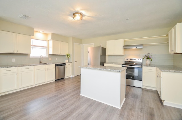 5343 Linda Ln, Katy, TX 77493 - kitchen featuring open shelves, a sink, stainless steel appliances, extractor fan, and light wood-type flooring