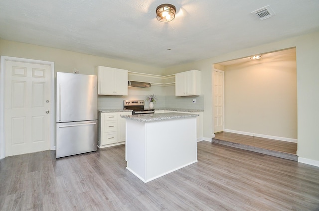 5343 Linda Ln, Katy, TX 77493 - kitchen featuring visible vents, a kitchen island, light wood-type flooring, appliances with stainless steel finishes, and white cabinets