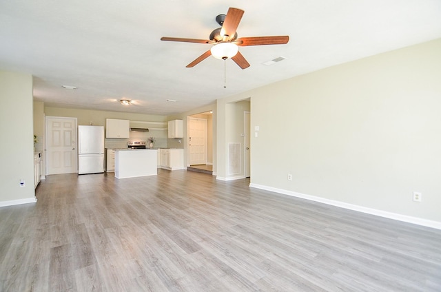 5343 Linda Ln, Katy, TX 77493 - unfurnished living room with baseboards, visible vents, light wood finished floors, and ceiling fan