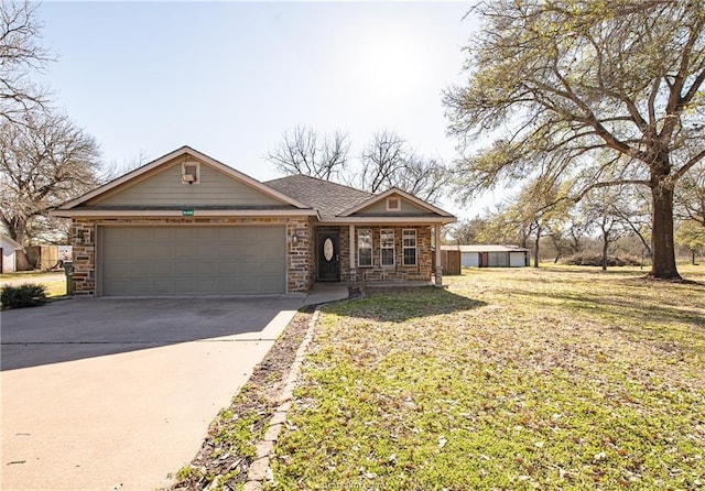 view of front of house featuring concrete driveway, a garage, stone siding, and a front lawn