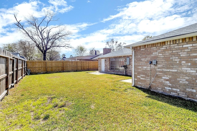 view of yard with a fenced backyard