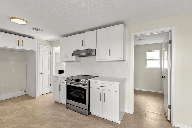 kitchen with visible vents, under cabinet range hood, white cabinetry, stainless steel range with electric cooktop, and light countertops