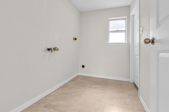 laundry area with laundry area and baseboards